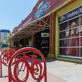 a store front with a red bicycle rack