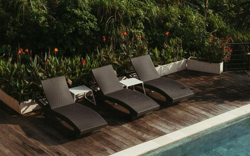 a group of chairs around a pool